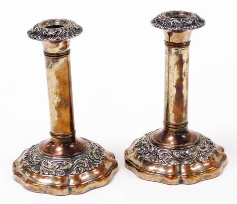 A pair of old Sheffield plate candlesticks, each with rococo style decoration on tapered bases, possibly c. 1800, 18cm high.