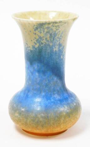 An early 20thC Ruskin pottery vase, in mottled blue and cream design, stamped Ruskin to underside, 18cm high.