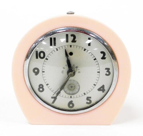 A Metalair Art Deco style clock, with a silver coloured face, in pink Bakelite surround, 16cm high, 15cm wide.