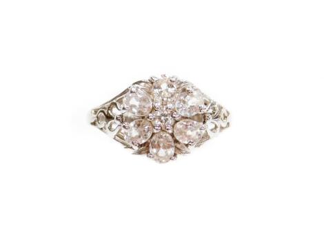 A 9ct white gold diamond dress ring, set in a floral cluster, on pierced design shoulders, ring size N, 3.4g all in, boxed.