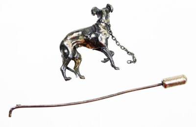 A late 20thC greyhound stick pin, the top with a silver coloured greyhound with red cabochon eyes, on a silver plated pin (AF), 9cm high. - 2