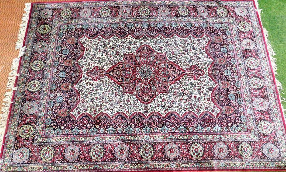 A Tabriz design carpet, the central medallion panel on a red cream