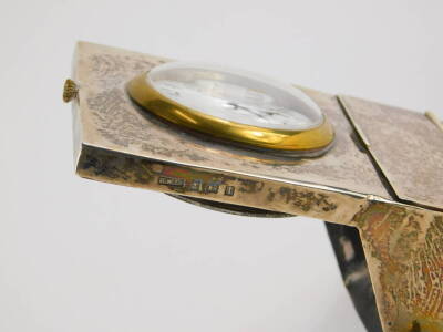 A George V silver mounted desk stand, of rectangular form, containing a pocket watch with brass bezel, a hinged lid enclosing a brush and two inkwells and two clips, possibly for a quill pen, Birmingham 1910. - 3