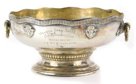 A George V small silver presentation bowl or punch bowl, with a gadrooned shaped edge, two handles, engraved Uganda Open Amateur Championship Cup, presented by Sir W E Gowers, K. C. M. G, 1937, London 1931, 10¼oz, 15cm diameter.