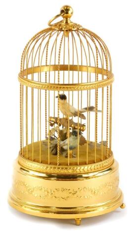 A 20thC Swiss musical bird cage, containing two feather clad birds, on the base decorated with swags, scrolls, etc., stamped to underside Reuge Music, Sainte-Coix Made in Switzerland, 5346, 32cm high.