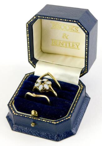 A Brooks and Bentley The Opal Dream Triple ring, with two wishbone design 9ct rings, each set with tiny diamonds, ring size T, and a central 9ct gold dress ring, set with opals and sapphires, ring size R, in presentation box, with certificate, 5g all in.