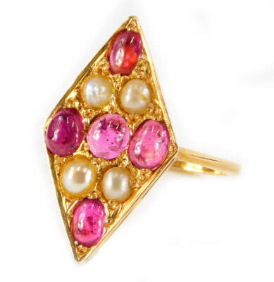 A marquise shaped ruby and pearl dress ring, the marquise design set with five rubies and four pearls, in yellow metal setting, unmarked, ring size L, 3.1g all in.