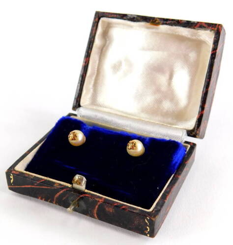 A pair of cultured pearl earrings, each with single pearl and gold six point flower end, on screw on butterfly backs, yellow metal, unmarked, 2.6g all in, boxed.