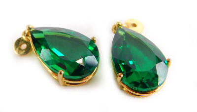 A pair of green paste stone earring drops, in gold plated frame with single loop to top.