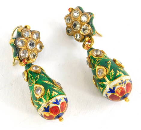 A pair of diamond and enamel drop earrings, the top in the form of a floral cluster set with seven old cut diamonds, on a pendant drop, set with various tiny diamonds, on a green enamel background, with a red, cream and blue flower to base, yellow metal, 