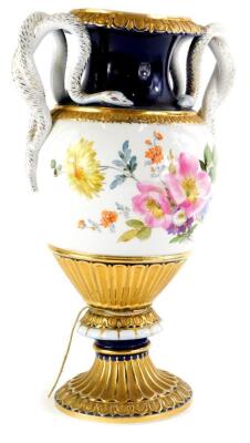 A late 19th/early 20thC German porcelain vase, pained with flowers within gilt and cobalt blue borders, mounted with two serpent shaped handles, blue Meissen type cross swords marked to underside, 28cm high.