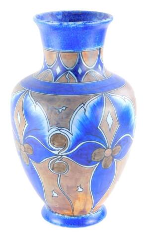 A Clews and Co Chameleon ware Art Deco vase, decorated with scrolls in brown, etc., on a blue ground, printed mark to underside, 38cm high.