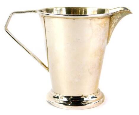 A George VI silver cream jug, the plain body with a plain spout and angular ear handle, engraved Mary, Birmingham 1944, 2½oz, 8cm high, (AF).