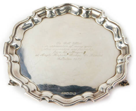 An Elizabeth II silver salver, with piecrust border on shell supports, with the inscription to Bill Elliott in appreciation of the many years close association and friendship from his colleagues at Anglo Hispano Bodega Co. Limited, Gibraltar 1973, Sheffie