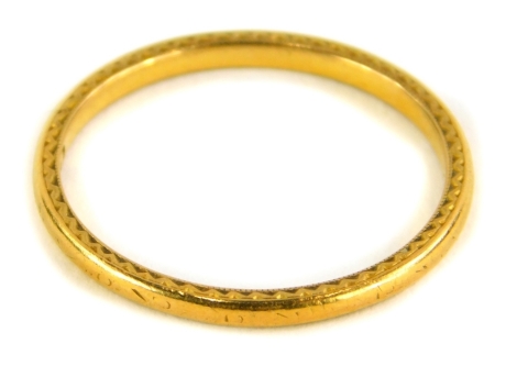 A 22ct gold thin wedding band, with rubbed etched decoration, Birmingham, ring size S, 2.6g.