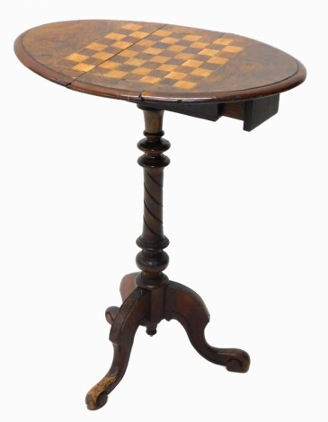 A Victorian walnut games table, the oval drop leaf top inlaid with a chess board, on turned column and tripod base, (AF), 67cm high, 53cm wide.