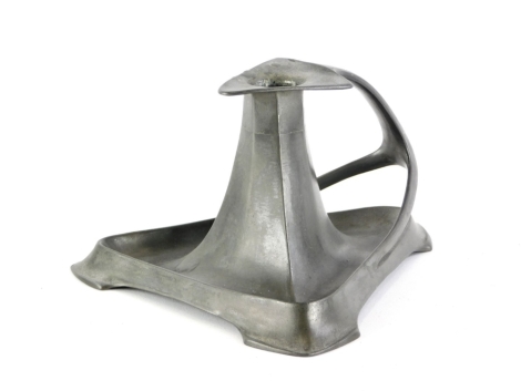 A late 19th/early 20thC art nouveau pewter chamber candlestick in the manner of Liberty, with triangular base and shaped handle, unmarked, 16cm deep.