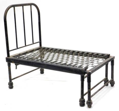 An unusual Victorian black painted iron adjustable campaign type bed, 113cm x 70cm enclosed.