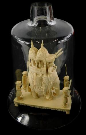 A late 19thC Indian carved ivory carving, modelled in the form of an elephant procession with four attendants on a rectangular base, with associated glass dome, 11cm wide.