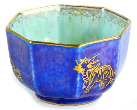 A Wedgwood Dragon lustre octagonal bowl, decorated centrally with a dragon on opalescent ground, the exterior in mottle blue, pattern number 4829, 7cm diameter.