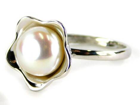 A silver dress ring, with central cluster design set with cultured pearl, ring size L½, 3.9g all in.