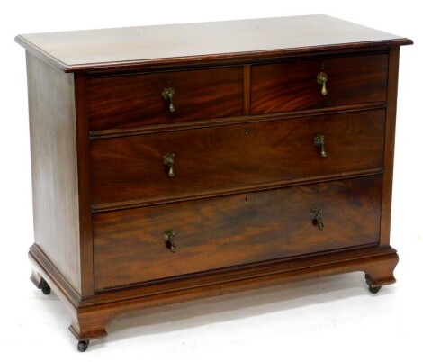 An early 20thC mahogany chest of drawers, the top with a moulded edge above two short and two long drawers, with brass tier drop handles and ogee bracket feet, with castors, 82cm high, 106cm wide, 52cm deep.