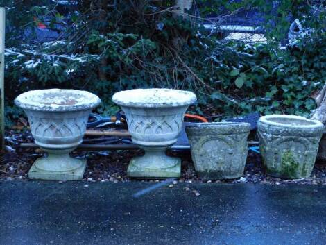 A pair of composition garden urns, each with a lattice design, on a square base, 44cm high, 45cm wide (1 AF), and a pair of composition garden planters, each decorated with figures, etc., 31cm high, 38cm wide. (4)