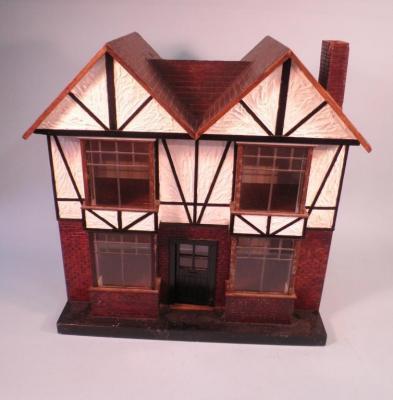 A dolls house in the form of a mock tudor double fronted house