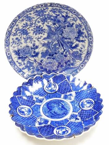 A Japanese Meiji style pottery plate, transfer printed with exotic birds and flowers, 31cm diameter, further 19thC blue and white plate, decorated with panels of birds and flowers. (2)