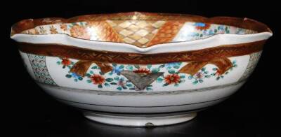 A Japanese lobed Satsuma bowl, decorated with overlapping shaped panels depicting women and children in a garden, books and gifts on a table, chrysanthemums, diaper designs, floral patterns, etc., the exterior with bands of fans, flowers, etc., illegible - 3