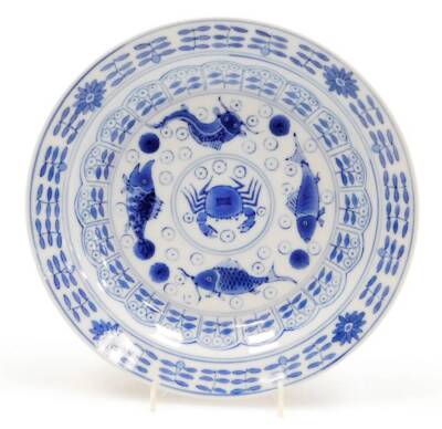 A late 19th/early 20thC Chinese blue and white saucer dish, decorated with fish, crabs, etc., in blue, four character mark to reverse, 20cm diameter.