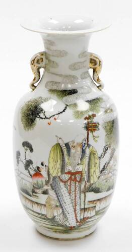 A 20thC Chinese porcelain vase, decorated in enamels with Shao Lao and his gnarled staff, surrounded by trees, with gilt elephant handles and calligraphy to the back, drilled, 35cm high.