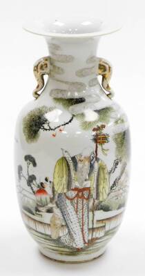 A 20thC Chinese porcelain vase, decorated in enamels with Shao Lao and his gnarled staff, surrounded by trees, with gilt elephant handles and calligraphy to the back, drilled, 35cm high.