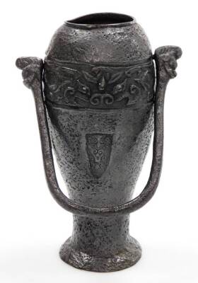 A bronze temple dog, with mouth open, raised on front paws, 14cm high, a vase of tapering circular form, with emblem to the centre and upper banding with swing handle, on a circular foot. (2) - 2