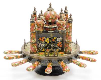 An Indian painted toasting machine, in the form of the Taj Mahal with various knives and forks inserted to the outer border, later converted to electricity, 32cm high x approx 26cm wide.