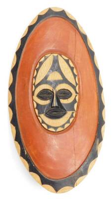 Tribal Art. A painted and carved timber wall mask, and two painted and timber shields, the wall mask 51cm high, 18cm wide, the shields 66cm high, 36m wide. (3) - 8