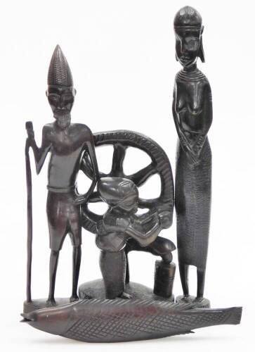 Tribal Art. Various carved wooden figures, to include a fish, 31cm wide, a group of a boy turning wheel, 28cm high, figure of an affluent gentleman in head dress with staff, 40cm high, and a blackened wooden figure of a lady, 45cm high. (4)