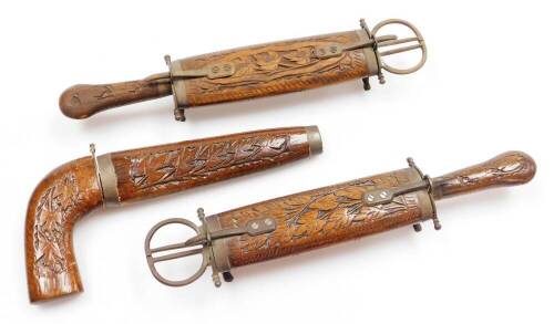 Three Indian teak knife & scissor sets, two on brass supports and pistol grip dagger, 29cm and 23cm long. (3)