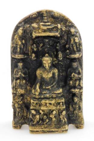 An Indian bronze Hindu shrine, of domed form cast centrally with Buddha seated on a lotus leaf, surrounded by further figures, 13cm high x 8cm wide.