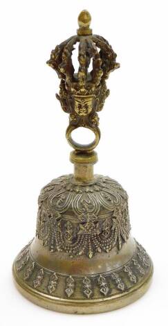 An Indian brass Hindu temple prayer bell, the handle of cast crown and deity mask form, 19cm high.