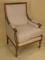 A Louis XVI style oak framed armchair with calico covers on square