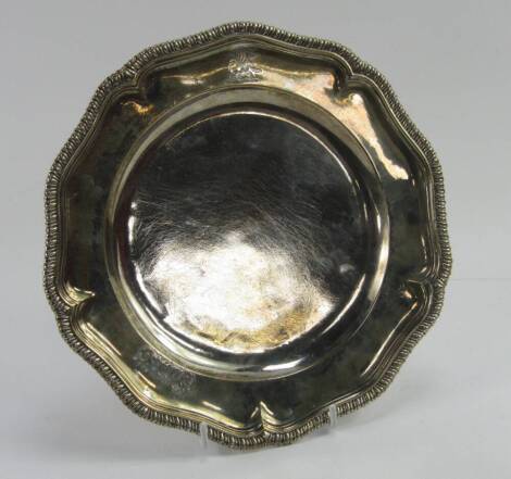 A William & Mary silver salver, with a gadrooned rim, crest and later monogram engraved, London 1698, approx 16.71t oz.