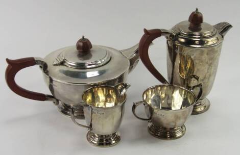 A silver four piece tea set, of fluted and footed form, Mappin & Webb, Sheffield 1954, 45.33t oz total weight.