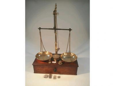 A set of 19thC brass and steel portable balance scales with mahogany base