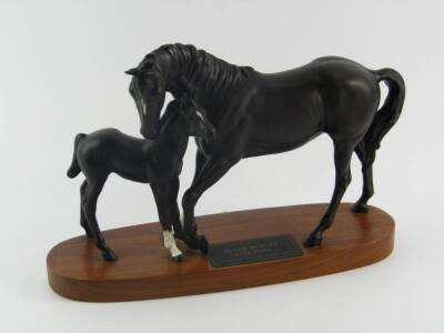 A Beswick figure of Black Beauty and foal, matt finish, Connoisseur model, raised on an oval wooden base.