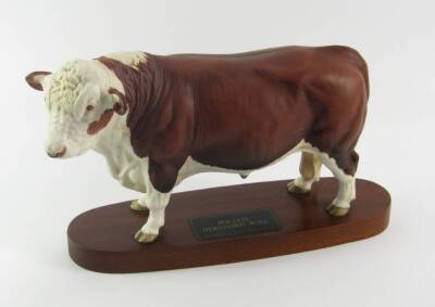 A Beswick figure of a Polled Hereford Bull, matt finish, connoisseur model, raised on an oval wooden base.