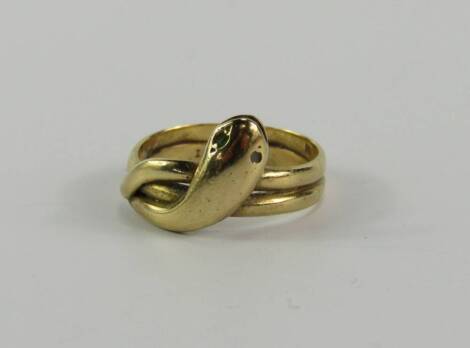 A yellow metal and gem set serpent ring, in a cross over design, stamped 18ct, size K, 3.8g.