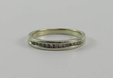 A white metal and diamond half hoop eternity ring, stamped 9ct, size K, 2.0g.