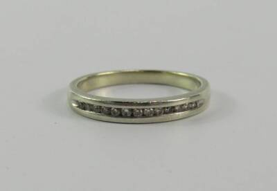 A white metal and diamond half hoop eternity ring, stamped 9ct, size K, 2.0g.