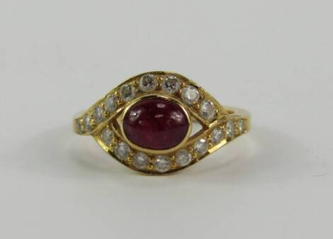 A yellow metal cabouchon ruby and diamond ring, in a cross over design, approx 0.6cts, size K, 4.5g.